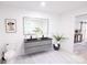 Contemporary bathroom with double vanity, modern toilet and access to another room at 8946 Glencroft Rd, Mint Hill, NC 28227