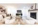 Open living room showcasing a cozy seating area, fireplace, and large TV at 8946 Glencroft Rd, Mint Hill, NC 28227