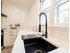 Modern kitchen sink with black faucet and stainless steel drying rack at 8946 Glencroft Rd, Mint Hill, NC 28227