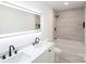 Clean bathroom with double sinks, a tub, and a walk-in shower at 8946 Glencroft Rd, Mint Hill, NC 28227