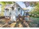 Home's rear elevation with wooden stairs and deck at 710 Wood St, Statesville, NC 28677