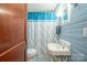Clean bathroom with a pedestal sink, shower, and blue walls at 710 Wood St, Statesville, NC 28677