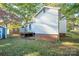 Side yard view showcasing a white home and wooden deck at 710 Wood St, Statesville, NC 28677
