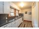 Bright kitchen features white cabinets, dark countertops, and a vintage feel at 710 Wood St, Statesville, NC 28677