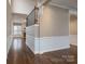 Open hallway showcasing hardwood floors and a modern half wall at 507 Quicksilver Trl, Fort Mill, SC 29708