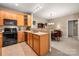 Open concept kitchen with dining area view and wood cabinets at 11923 Ridgeway Park Dr, Charlotte, NC 28277