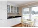 White kitchen cabinets with glass-front upper cabinets and granite countertops at 3540 Highway 324 Hwy, Rock Hill, SC 29732