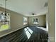 Spacious living room with hardwood floors, ceiling fan, and large windows at 1712 Mcdonald St, Charlotte, NC 28216