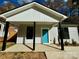 Newly built home with gray siding, teal door, and a covered porch at 1712 Mcdonald St, Charlotte, NC 28216