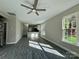 Spacious living room with hardwood floors, ceiling fan, and large windows at 1712 Mcdonald St, Charlotte, NC 28216