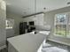 Modern kitchen with white cabinets, quartz countertops, and stainless steel appliances at 1712 Mcdonald St, Charlotte, NC 28216
