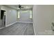Bright bedroom featuring wood-look floors and large windows at 1712 Mcdonald St, Charlotte, NC 28216