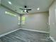 Spacious bedroom with wood-look floors and multiple windows at 1712 Mcdonald St, Charlotte, NC 28216