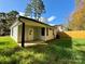 Newly constructed house with a light-colored exterior, covered porch, and a fenced backyard at 1712 Mcdonald St, Charlotte, NC 28216
