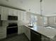 Modern kitchen with stainless steel appliances and white cabinets at 1712 Mcdonald St, Charlotte, NC 28216