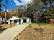 Newly built home with white exterior, light blue door, and a small front yard at 1712 Mcdonald St, Charlotte, NC 28216