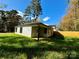 New construction home with a light-colored exterior, covered porch, and grassy yard at 1712 Mcdonald St, Charlotte, NC 28216
