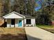 Newly built home with gray siding, teal front door, and a paved driveway at 1712 Mcdonald St, Charlotte, NC 28216