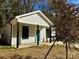 Newly constructed home with gray siding, a teal door, and a covered porch at 1712 Mcdonald St, Charlotte, NC 28216