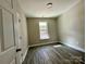 Spacious bedroom with wood-like floors and a window at 1712 Mcdonald St, Charlotte, NC 28216