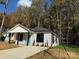 Newly built house featuring gray siding, a teal door, and a spacious front yard at 1712 Mcdonald St, Charlotte, NC 28216