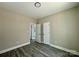 Bedroom with wood-look floors and access to bathroom at 1712 Mcdonald St, Charlotte, NC 28216