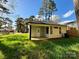 New construction home showcasing a light-colored exterior, covered porch and grassy yard at 1712 Mcdonald St, Charlotte, NC 28216