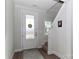 Bright entryway with wood floors, a white door, and a staircase leading upstairs at 140 Tanner Loop, Troutman, NC 28166