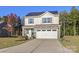 Two-story house with a two-car garage and solar panels at 140 Tanner Loop, Troutman, NC 28166