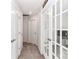 Bright hallway with carpet, two closed doors and french doors to an office at 140 Tanner Loop, Troutman, NC 28166