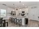 Spacious kitchen with granite island, white cabinets, and stainless steel appliances at 140 Tanner Loop, Troutman, NC 28166