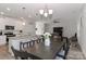 Kitchen and dining area with granite island and four-person table at 140 Tanner Loop, Troutman, NC 28166