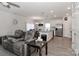 Open concept kitchen and living room with stainless steel appliances and grey reclining sofas at 140 Tanner Loop, Troutman, NC 28166