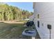 Backyard with patio, grill, fire pit, and wooded area at 140 Tanner Loop, Troutman, NC 28166
