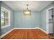 Bright dining room with hardwood floors and elegant light fixture at 615 E Ridge St, Kings Mountain, NC 28086