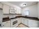 Galley kitchen with white cabinets, granite countertops, and appliances at 806 Bridgewood Dr, Rock Hill, SC 29732