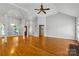 Open living room with hardwood floors, high ceilings, and a fireplace at 4823 Morris Glen Dr, Concord, NC 28027