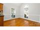 Bright breakfast nook with hardwood floors and large windows at 4823 Morris Glen Dr, Concord, NC 28027