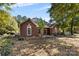 Brick home with landscaped yard and mature trees at 4823 Morris Glen Dr, Concord, NC 28027