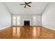 Living room with hardwood floors, fireplace, and French doors at 4823 Morris Glen Dr, Concord, NC 28027