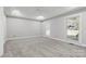 Spacious bedroom with neutral walls, carpet flooring, and ample natural light at 4823 Morris Glen Dr, Concord, NC 28027