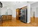 Spacious kitchen with wood cabinets, stainless steel appliances, and hardwood floors at 4823 Morris Glen Dr, Concord, NC 28027