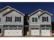 Two-unit townhome building with gray siding, stone accents, and attached garages at 4057 Port Richmond Ave # 13, Gastonia, NC 28056