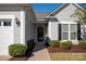 Inviting front yard with a walkway, shrubs, and a black front door at 7011 Kitty Hawk Ln, Fort Mill, SC 29707