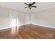 Bright bedroom featuring hardwood floors, two closets, and a ceiling fan at 405 S Church St, Monroe, NC 28112