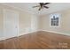 Well-lit bedroom with hardwood floors, closets, and a window at 405 S Church St, Monroe, NC 28112