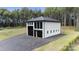 Modern concrete garage with black metal roof and large glass doors at 248 Singleton Rd # 25, Mooresville, NC 28117