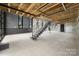 Modern staircase in open concept interior with large windows at 248 Singleton Rd # 25, Mooresville, NC 28117