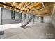 Modern staircase in an open concept interior with exposed beams and large windows at 248 Singleton Rd # 25, Mooresville, NC 28117