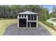 Modern concrete garage with black metal roof and large glass doors at 248 Singleton Rd # 25, Mooresville, NC 28117